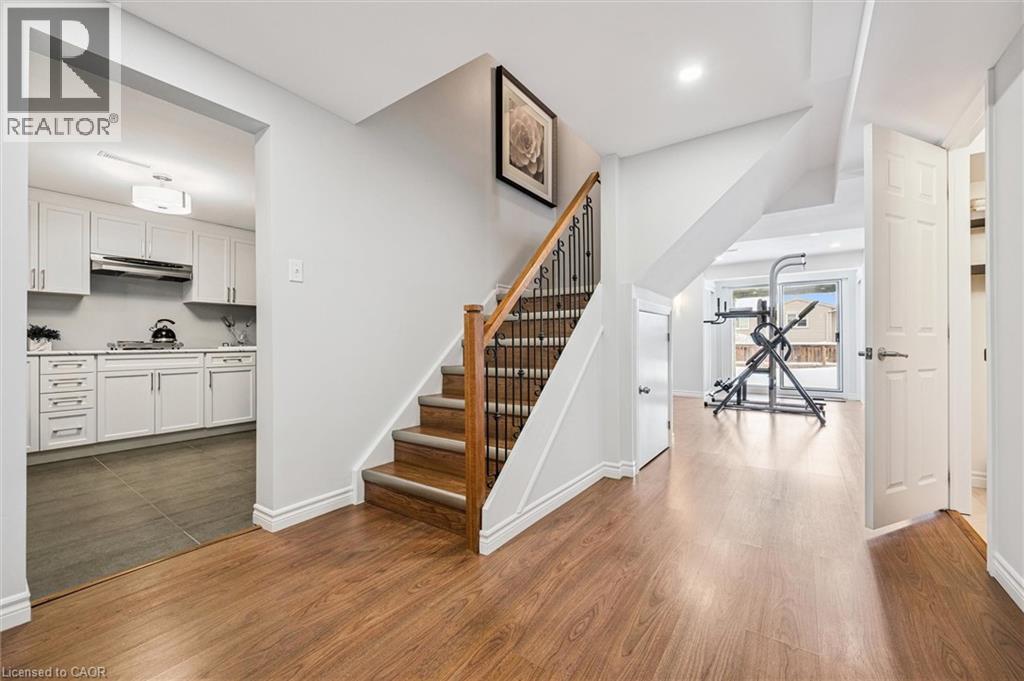Interior features wood-finish flooring throughout the main level - 488 Heather Hill Place, Waterloo, ON - Indoor