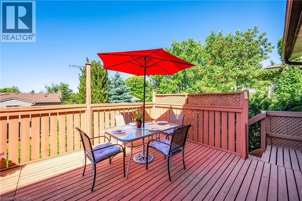 Spacious wood-decked patio with protective railings and privacy lattice - 488 Heather Hill Place, Waterloo, ON - Outdoor With Deck Patio Veranda With Exterior