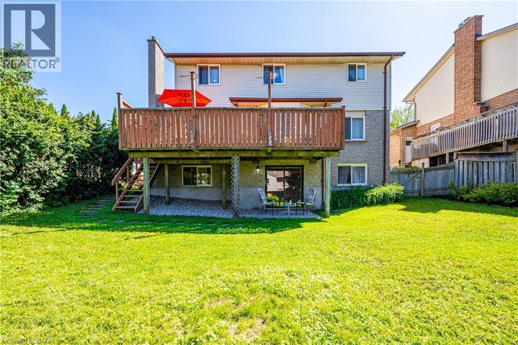 Rear exterior with a spacious wooden deck featuring wood railings and stairs - 488 Heather Hill Place, Waterloo, ON - Outdoor With Deck Patio Veranda