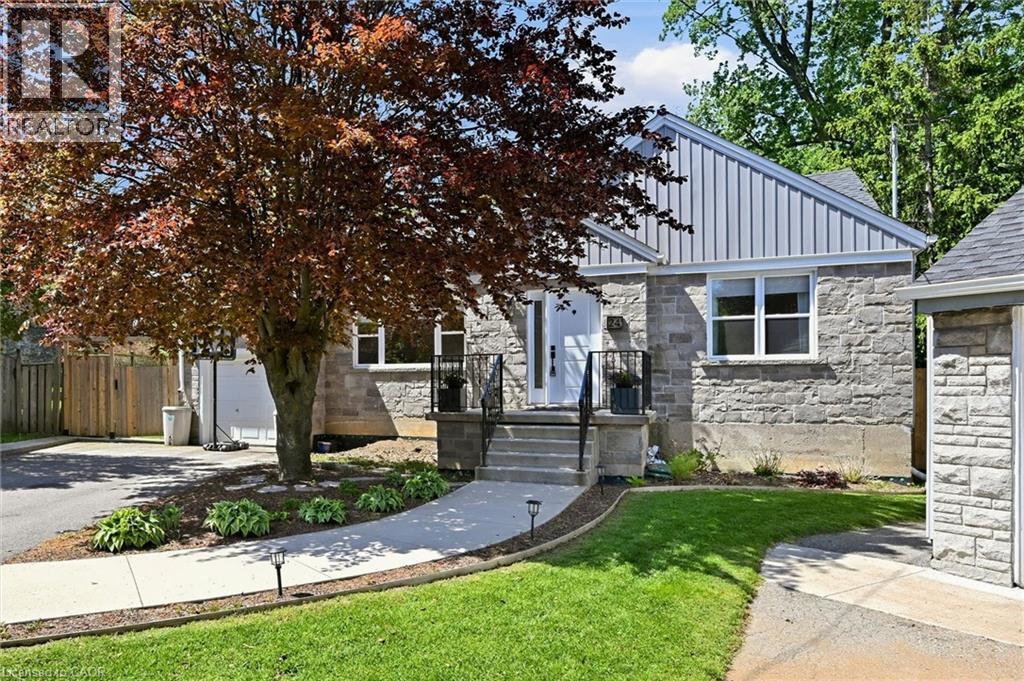 Stone facade home with a prominent red-leafed tree and manicured lawn - 24 Glenwood Crescent, Hamilton, ON - Outdoor