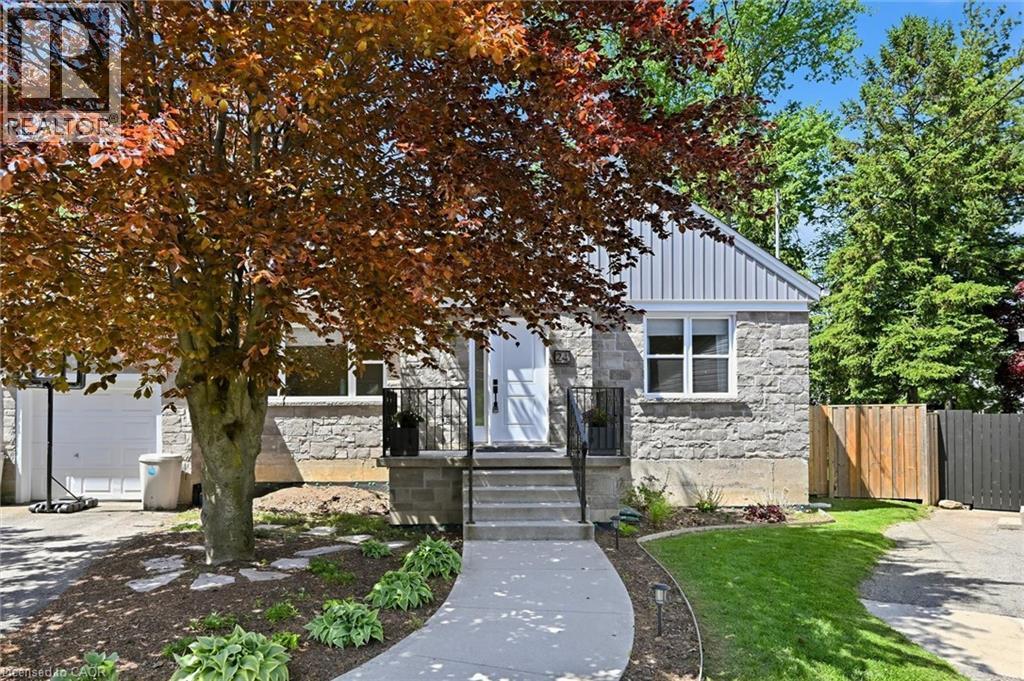 Stone facade residence featuring a front entry concrete walkway, mature landscaping, and a fenced side yard - 24 Glenwood Crescent, Hamilton, ON - Outdoor