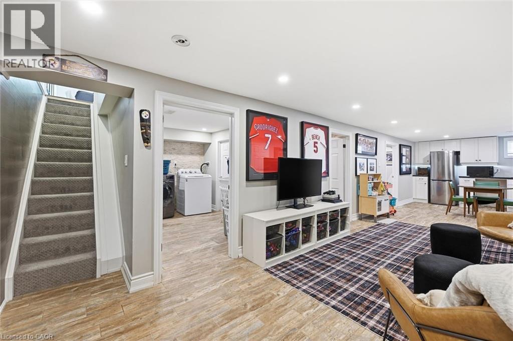 Spacious finished lower level featuring wood-finish flooring, recessed lighting, and a neutral color palette - 24 Glenwood Crescent, Hamilton, ON - Indoor
