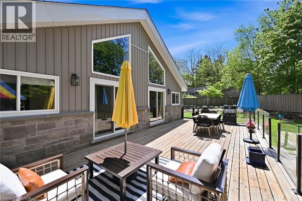 Expansive wood-finish deck with glass panel railing - 24 Glenwood Crescent, Hamilton, ON - Outdoor With Deck Patio Veranda