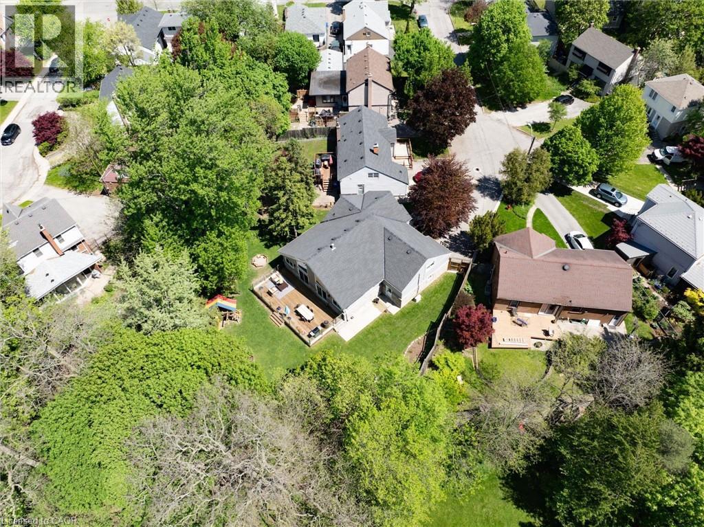 Expansive property featuring a multi-level deck, mature trees, and a spacious green lawn - 24 Glenwood Crescent, Hamilton, ON - Outdoor With View