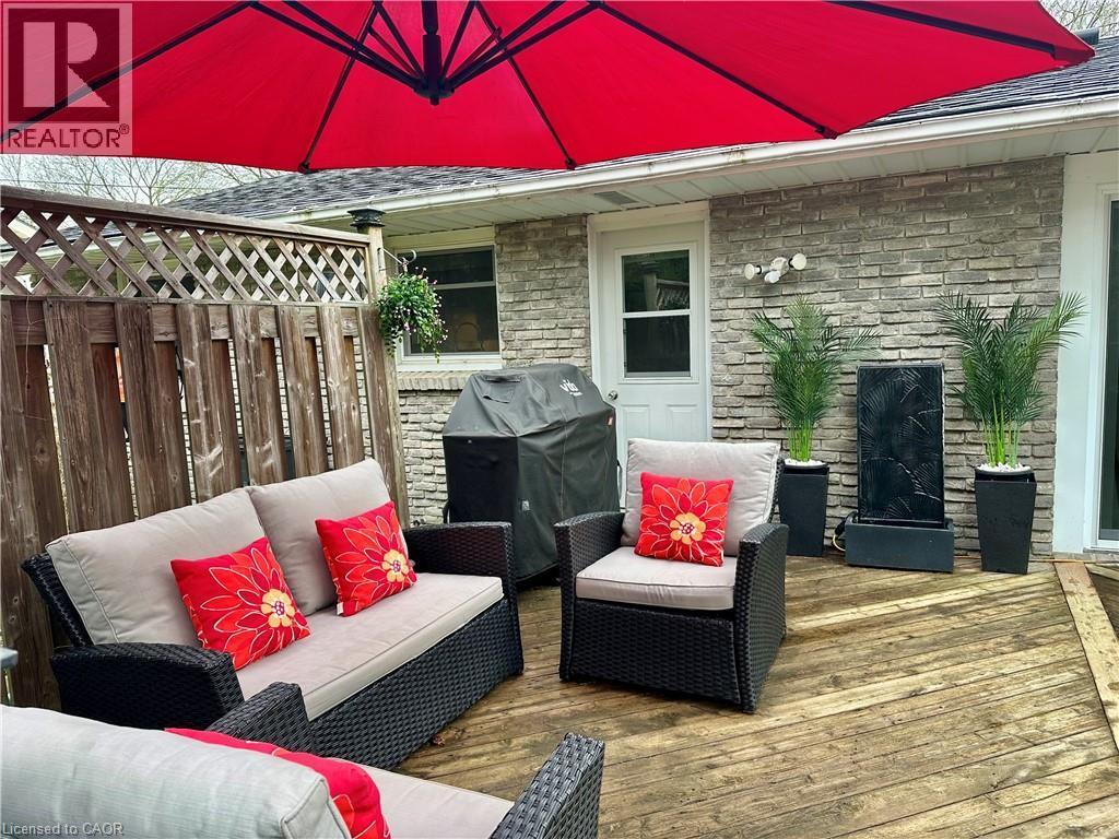 This property features an inviting outdoor living area with a wooden deck - 70 Berkley Crescent, Simcoe, ON - Outdoor With Deck Patio Veranda