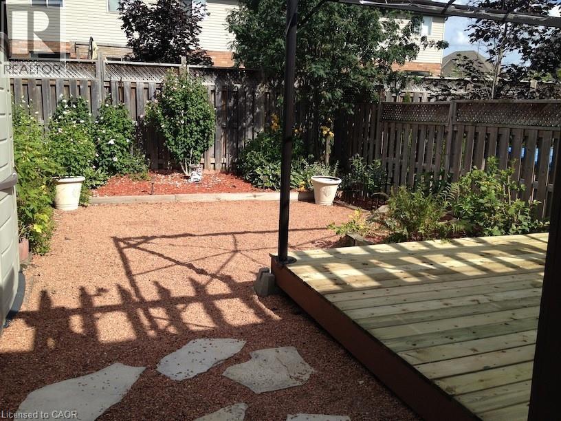 Outdoor living space featuring a wood deck, gravel patio, and stone pavers - 37 Northcliffe Crescent, Cambridge, ON - Outdoor