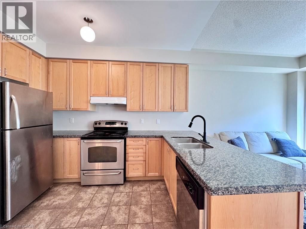 Kitchen featuring light wood cabinetry, stainless steel appliances, granite-style countertops, and tiled flooring - 110 Highland Road E Unit# 53, Kitchener, ON - Indoor Photo Showing Kitchen With Double Sink