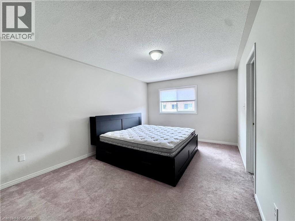 Bedroom featuring neutral-toned carpeting, white painted walls, a standard window, and an overhead flush-mount light fixture - 110 Highland Road E Unit# 53, Kitchener, ON - Indoor Photo Showing Bedroom