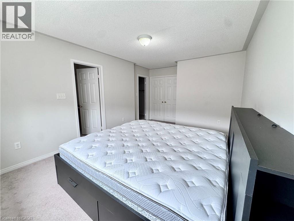 Carpeted bedroom with light gray walls, white trim, and a semi-flush mount ceiling light - 110 Highland Road E Unit# 53, Kitchener, ON - Indoor Photo Showing Bedroom