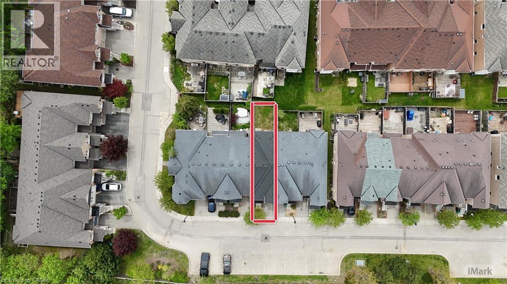 Townhome property with a private fenced yard and asphalt shingle roofing - 110 Highland Road E Unit# 53, Kitchener, ON -