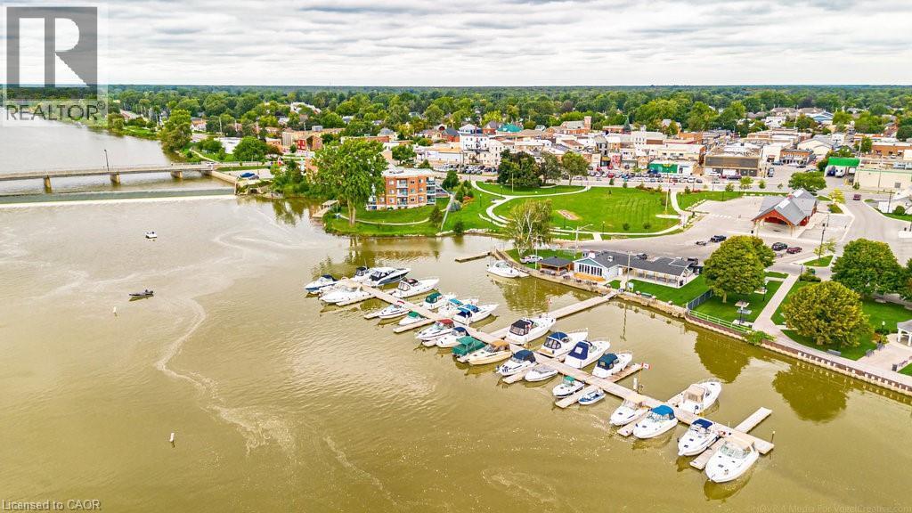 Waterfront properties featuring a marina with multiple boat slips, a public green space, and a community bridge - 32A Haldimand Trail, Dunnville, ON - Outdoor With Body Of Water With View