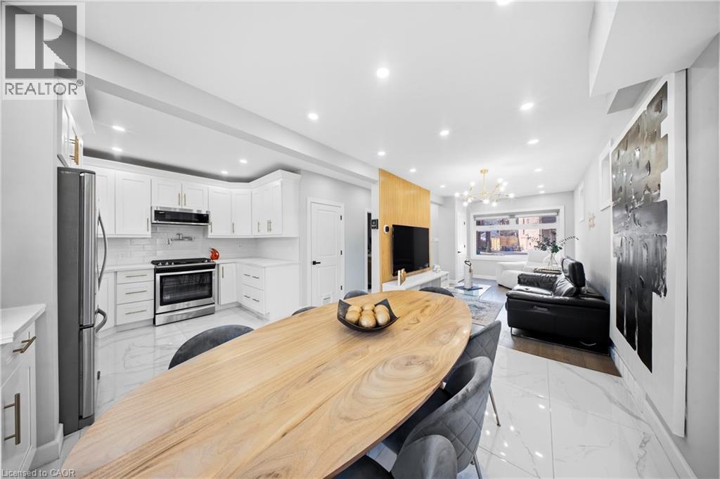 Dining space featuring a chandelier and light marble finish flooring - 273 Stinson Crescent, Hamilton, ON - Indoor Photo Showing Kitchen With Upgraded Kitchen