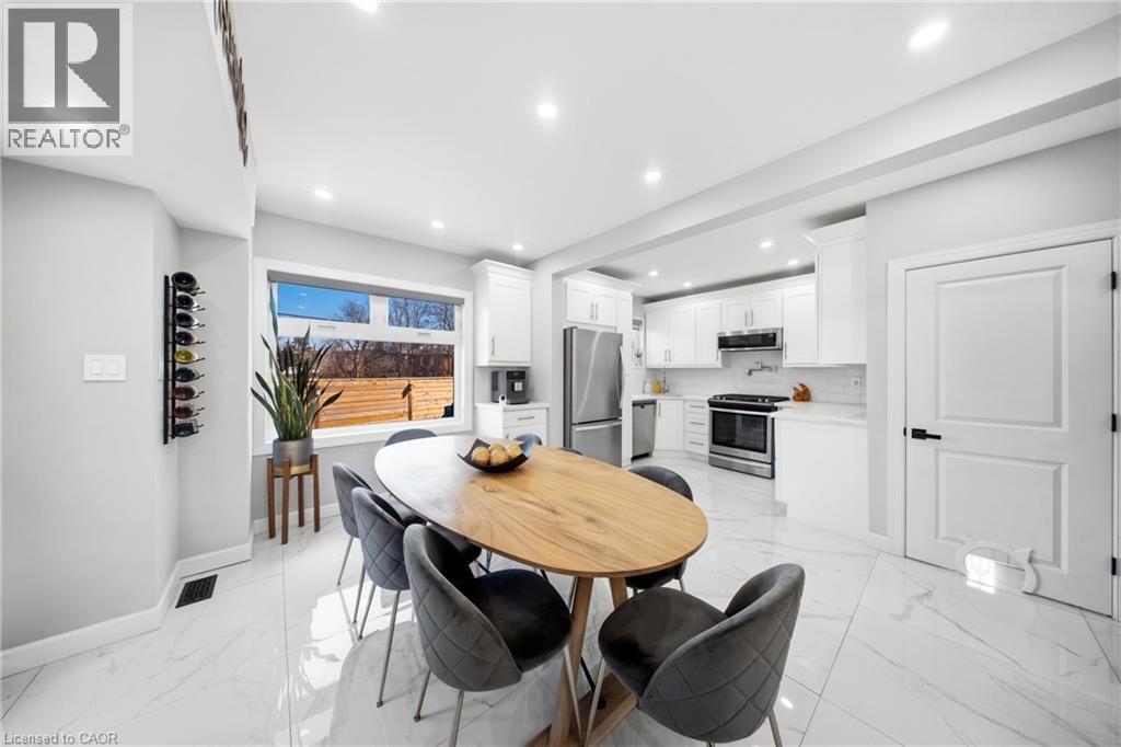 Dining area with light marble finish floors and recessed lighting - 273 Stinson Crescent, Hamilton, ON - Indoor