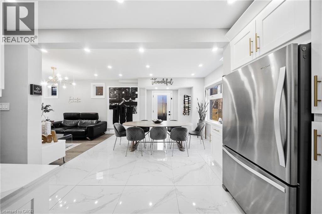 Dining room featuring light marble finish floors and hanging lights - 273 Stinson Crescent, Hamilton, ON - Indoor
