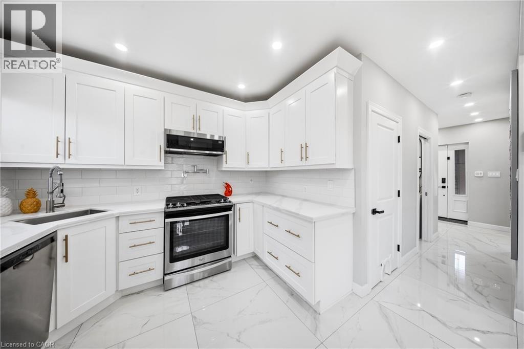Kitchen featuring stainless steel appliances, light marble finish flooring, white cabinets, and recessed lighting - 273 Stinson Crescent, Hamilton, ON - Indoor Photo Showing Kitchen