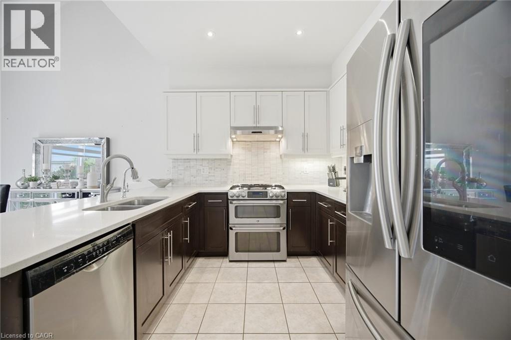 Modern kitchen featuring a stainless steel French door refrigerator, a stainless steel range with a double oven, and a stainless steel dishwasher - 58 Doon Creek Street, Kitchener, ON - Indoor Photo Showing Kitchen With Double Sink With Upgraded Kitchen