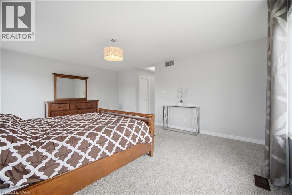 Spacious room with light gray walls and plush carpet - 58 Doon Creek Street, Kitchener, ON - Indoor Photo Showing Bedroom