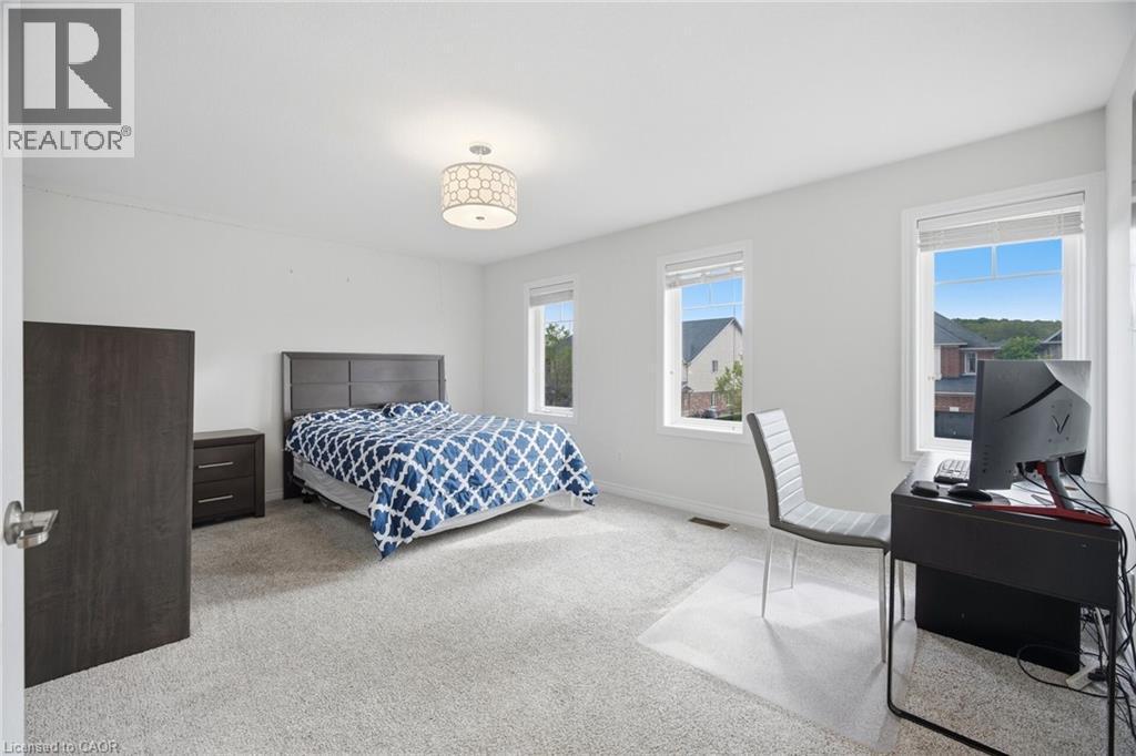 Spacious room featuring light-colored carpeting and white walls - 58 Doon Creek Street, Kitchener, ON - Indoor Photo Showing Bedroom