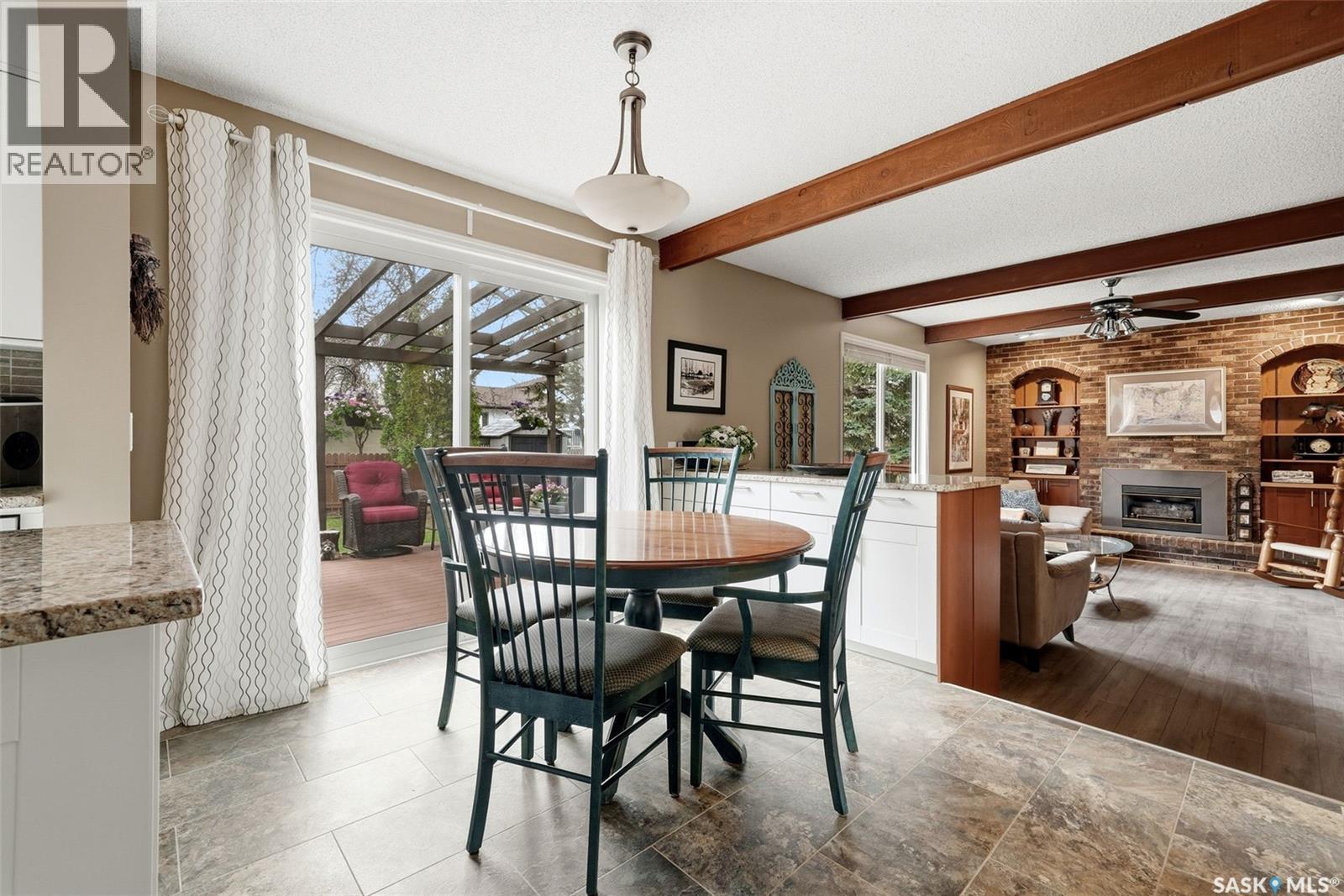 7 Cowie Road, Regina, SK - Indoor Photo Showing Dining Room With Fireplace
