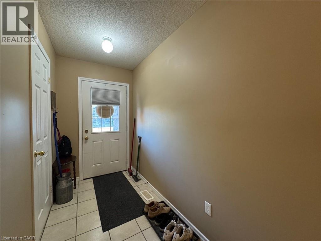 Entryway featuring neutral wall tones, white paneled doors, and a tiled floor - 517 Northbrook Place, Kitchener, ON - Indoor Photo Showing Other Room