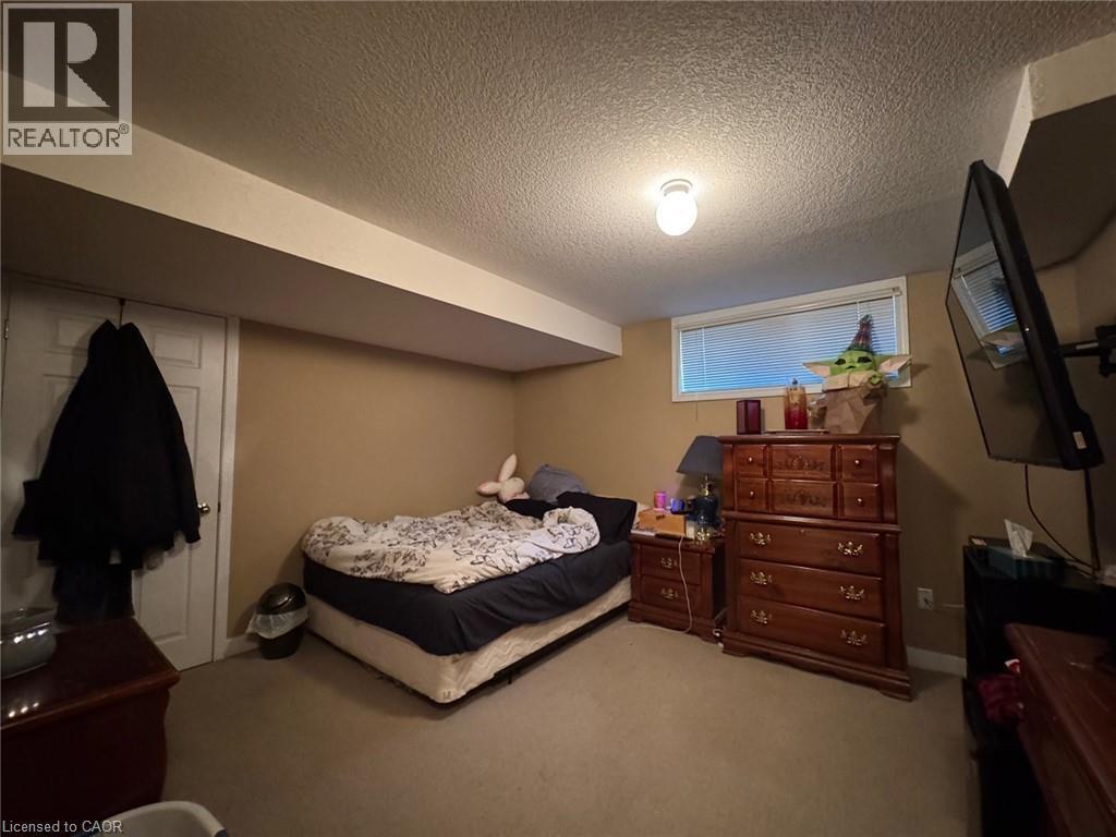 Carpeted room featuring a single window, a white interior door, and light-toned walls - 517 Northbrook Place, Kitchener, ON - Indoor Photo Showing Bedroom