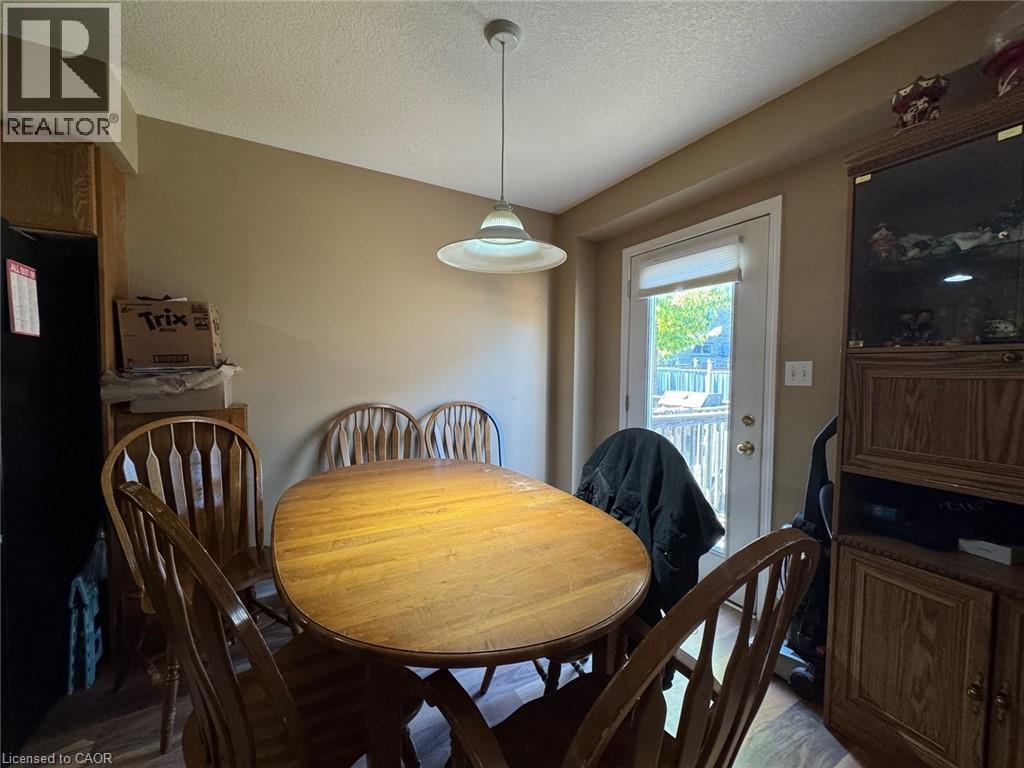 Dining area featuring a white drum pendant light and direct access to an outdoor deck - 517 Northbrook Place, Kitchener, ON - Indoor Photo Showing Dining Room