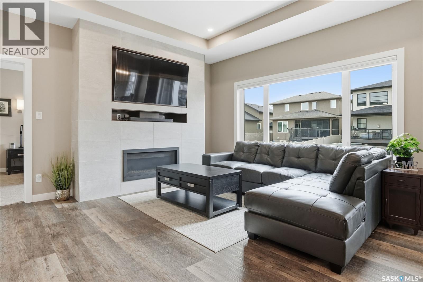 4264 Elderberry Crescent E, Regina, SK - Indoor Photo Showing Living Room With Fireplace