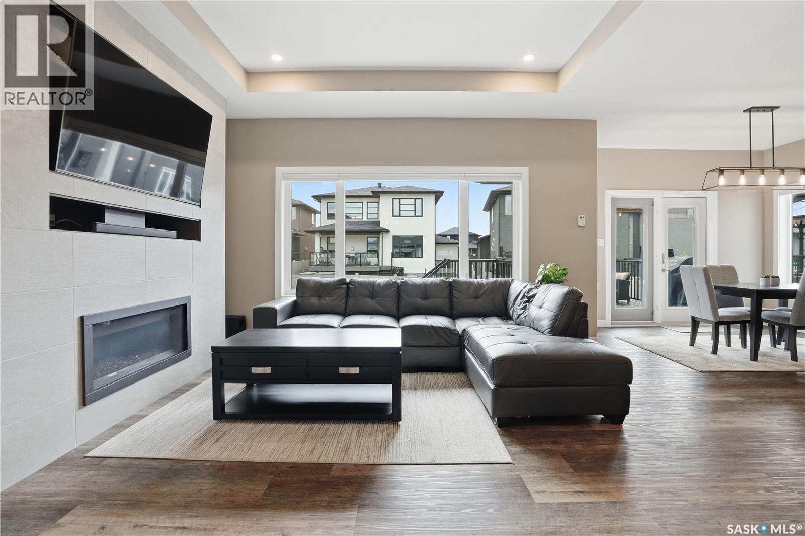 4264 Elderberry Crescent E, Regina, SK - Indoor Photo Showing Living Room With Fireplace