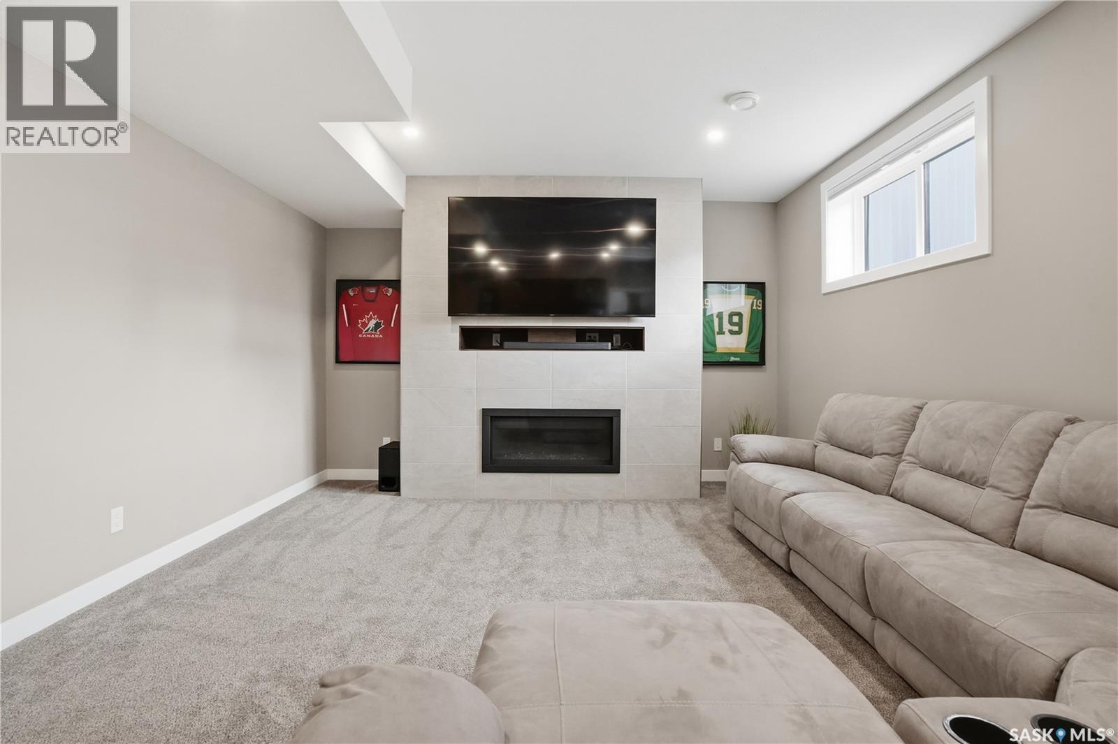 4264 Elderberry Crescent E, Regina, SK - Indoor Photo Showing Living Room With Fireplace
