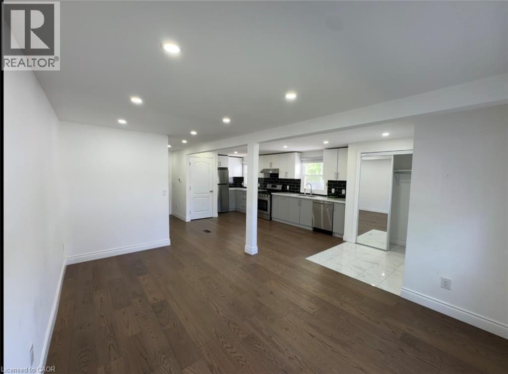 Spacious living area featuring wood-finish flooring, recessed lighting, and white baseboards - 28 Timberlane Crescent Unit# Upper, Kitchener, ON - Indoor