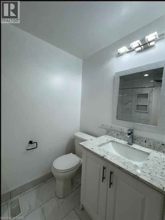 Bathroom featuring a white vanity with a granite countertop and integrated sink - 28 Timberlane Crescent Unit# Upper, Kitchener, ON - Indoor Photo Showing Bathroom