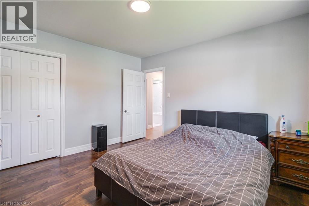 Spacious room featuring wood-finish flooring, light grey wall paint, and white trim - 100 Lauris Avenue, Cambridge, ON - Indoor Photo Showing Bedroom