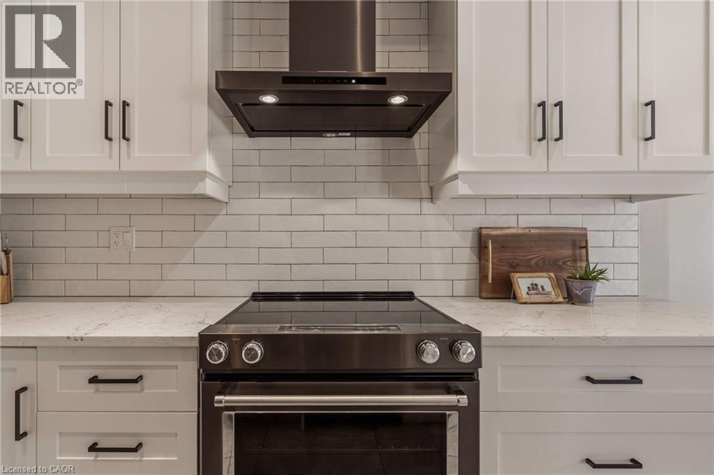 Upgraded range hood. - 81 Beasley Grove, Ancaster, ON - Indoor Photo Showing Kitchen