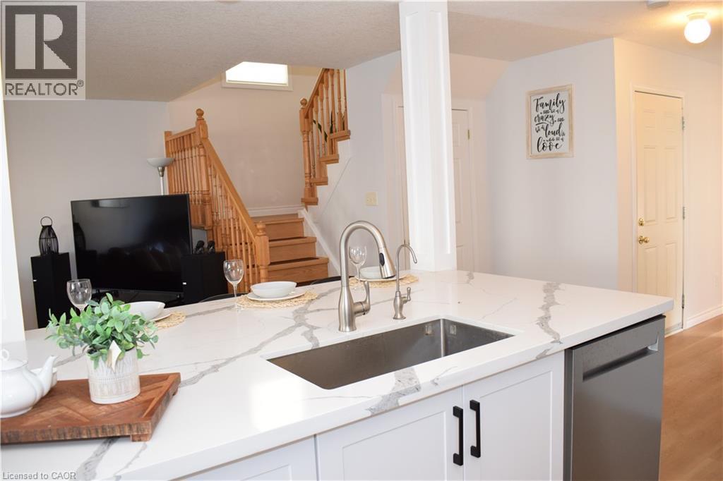 Kitchen island featuring a stainless steel undermount sink and a pull-down faucet - 28 Lemon Grass Street, Kitchener, ON - Indoor Photo Showing Kitchen