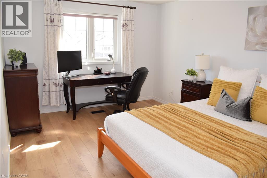 Bedroom featuring light wood-finish flooring and a large window - 28 Lemon Grass Street, Kitchener, ON - Indoor Photo Showing Bedroom