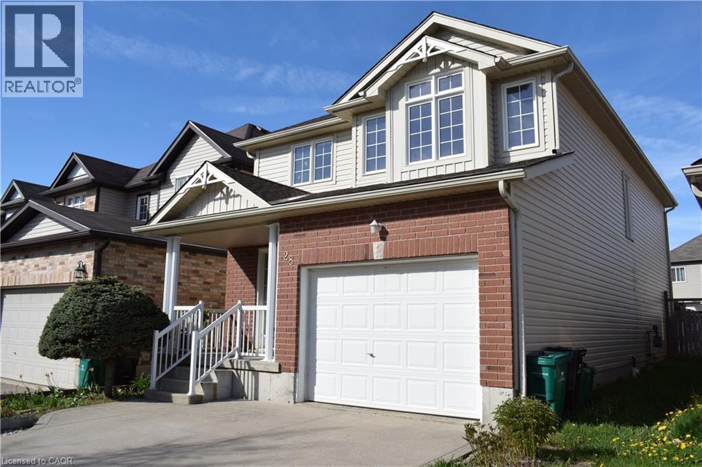 Exterior featuring a brick facade, light-toned siding, and an attached single-car garage - 28 Lemon Grass Street, Kitchener, ON - Outdoor