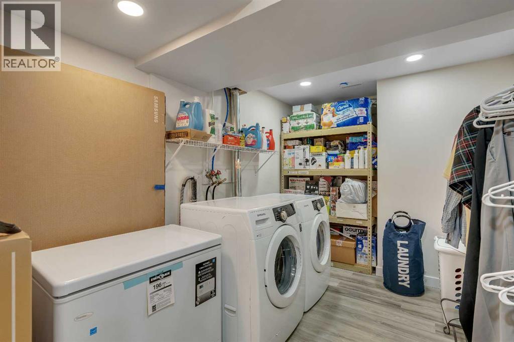 LVP even in the laundry room - 245 Auburn Crest Way Se, Calgary, AB - Indoor Photo Showing Laundry Room
