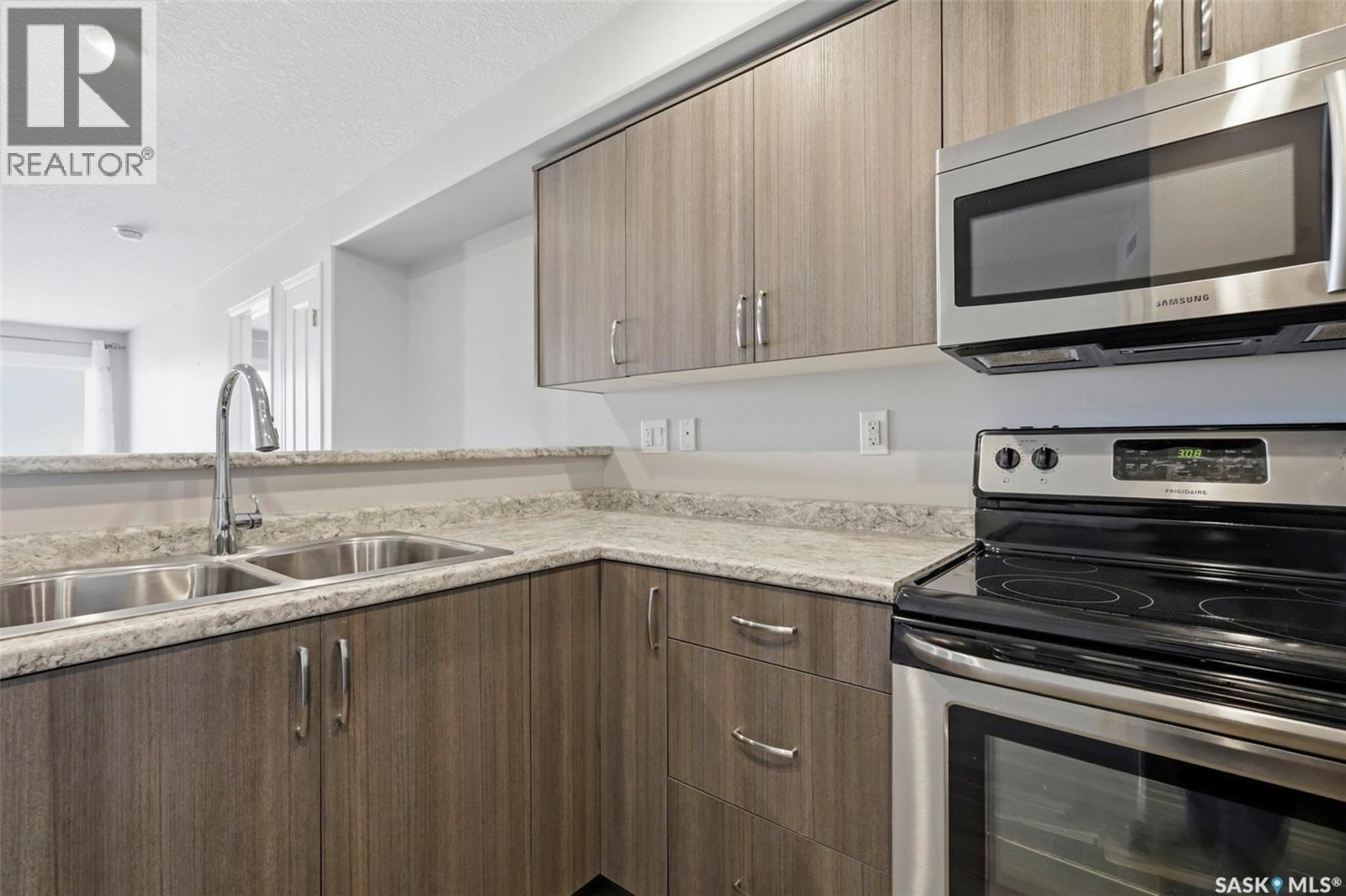 209 915 Kristjanson Road, Saskatoon, SK - Indoor Photo Showing Kitchen With Double Sink