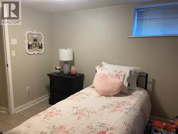 Neutral wall finishes with white trim, light tile flooring, and an elevated window -