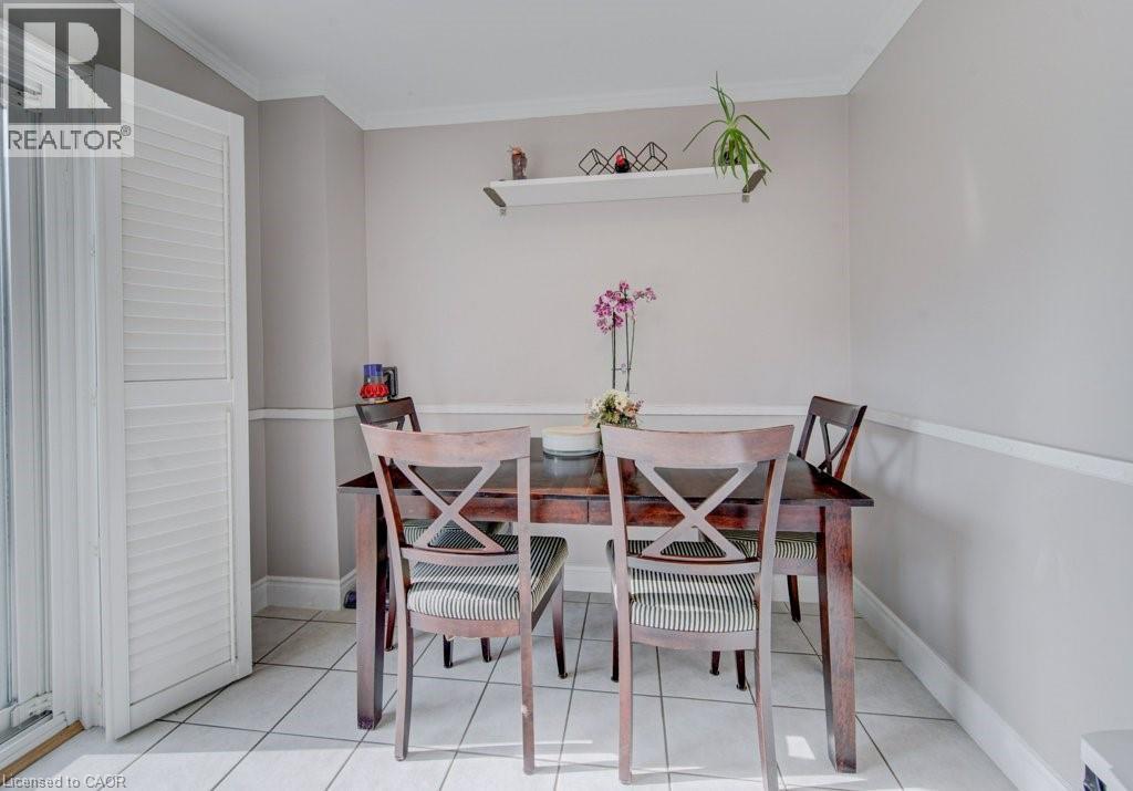Dining area featuring neutral wall tones, white crown molding, chair rail molding, and a white floating shelf - 334 Christopher Drive, Cambridge, ON - Indoor Photo Showing Dining Room
