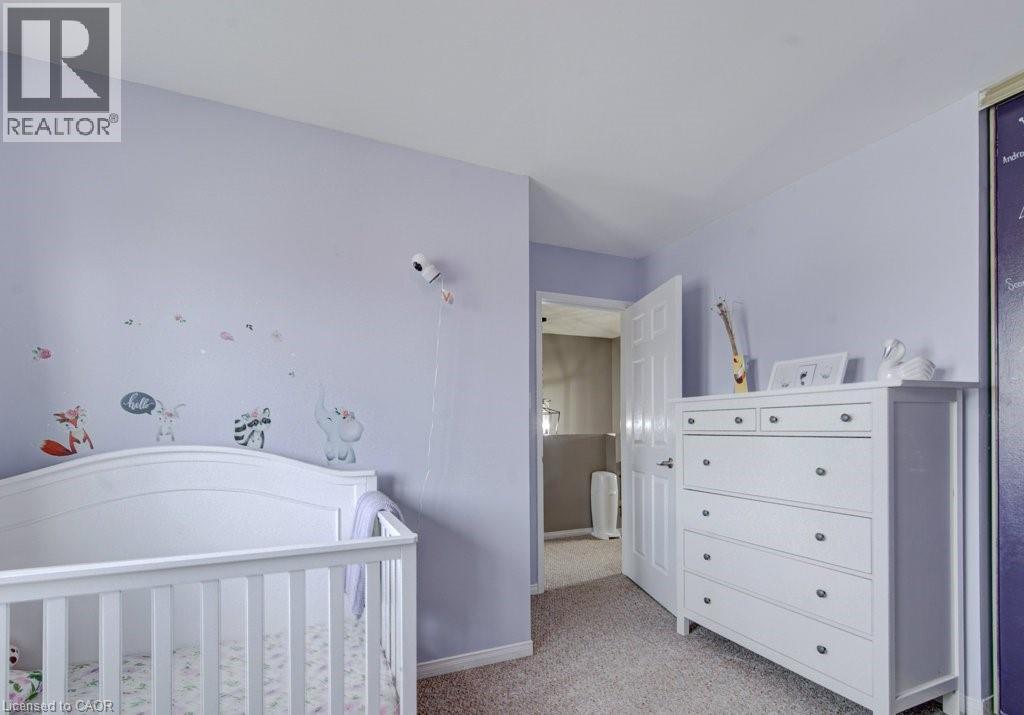 Room featuring light purple wall paint and textured carpet flooring - 334 Christopher Drive, Cambridge, ON - Indoor Photo Showing Other Room