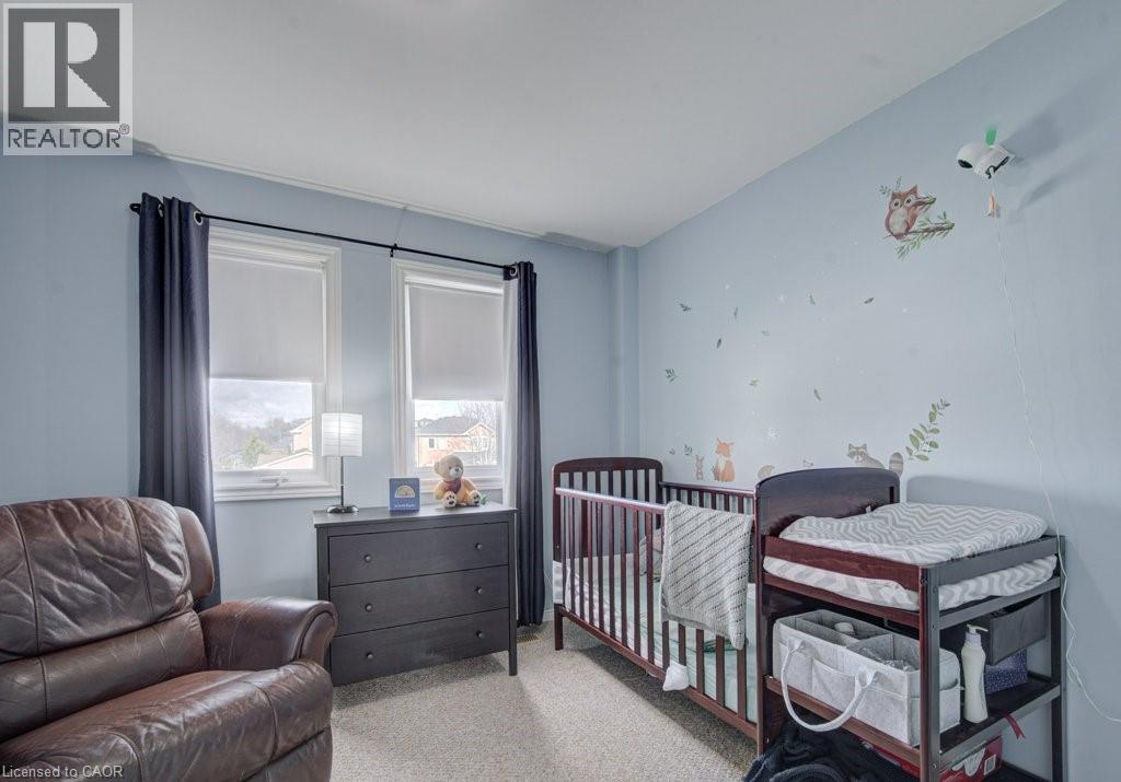 Light blue walls with white baseboards and crown molding - 334 Christopher Drive, Cambridge, ON - Indoor Photo Showing Bedroom