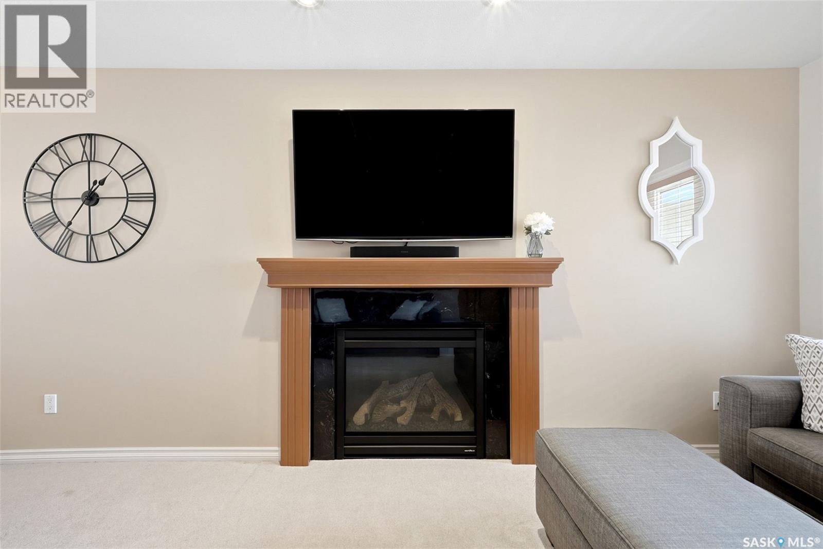 2090 Laurier Bay E, Regina, SK - Indoor Photo Showing Living Room With Fireplace