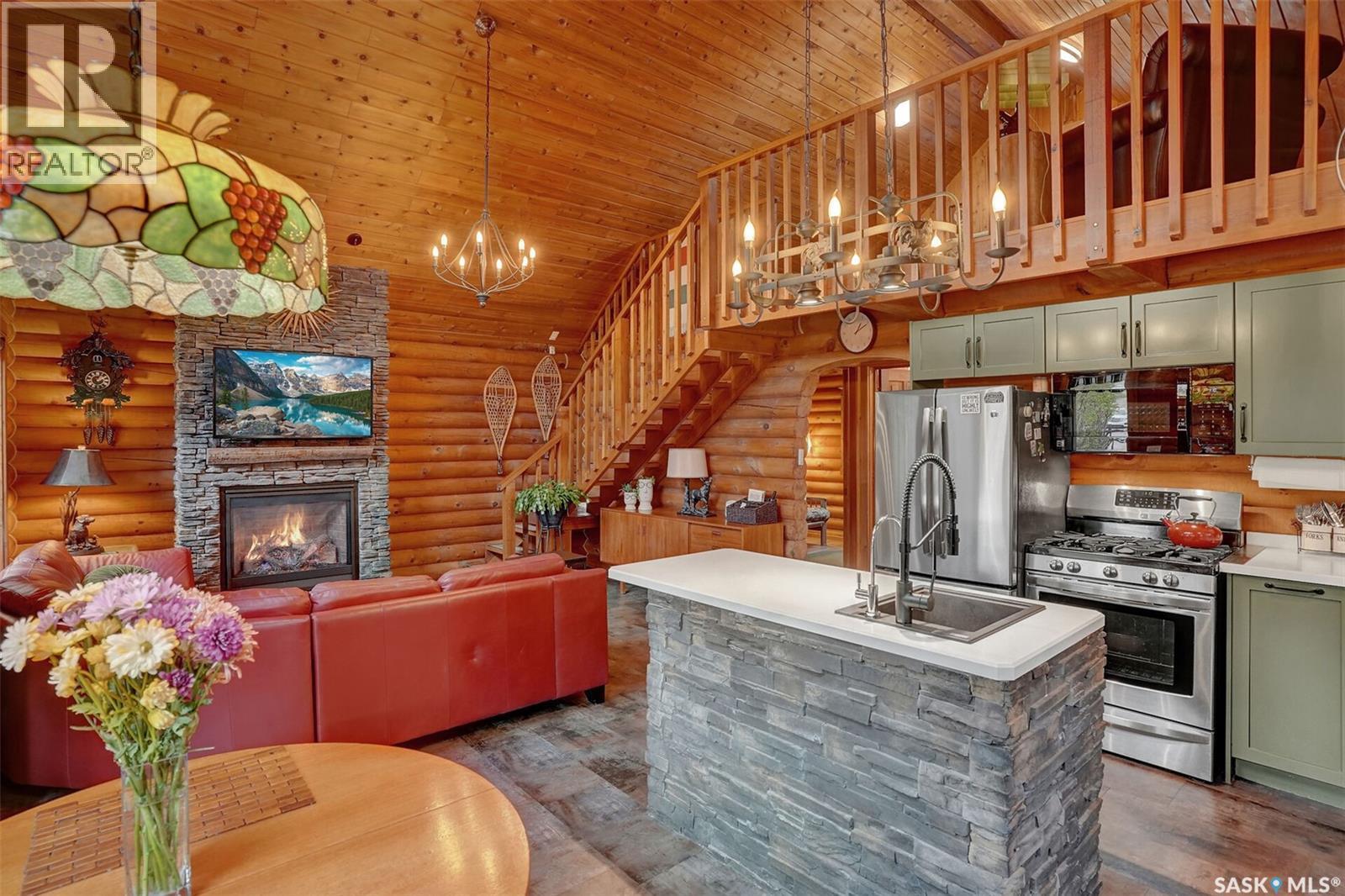 109 Shaw Drive, Regina Beach, SK - Indoor Photo Showing Kitchen With Fireplace