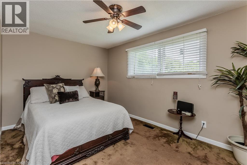 Neutral-toned walls complement the textured brown carpet - 643 Artreva Crescent, Burlington, ON - Indoor Photo Showing Bedroom