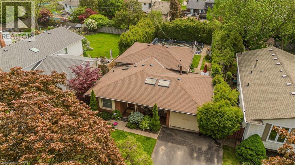 Brown shingle roofing with skylights, attached garage, and mature perimeter landscaping - 643 Artreva Crescent, Burlington, ON - Outdoor