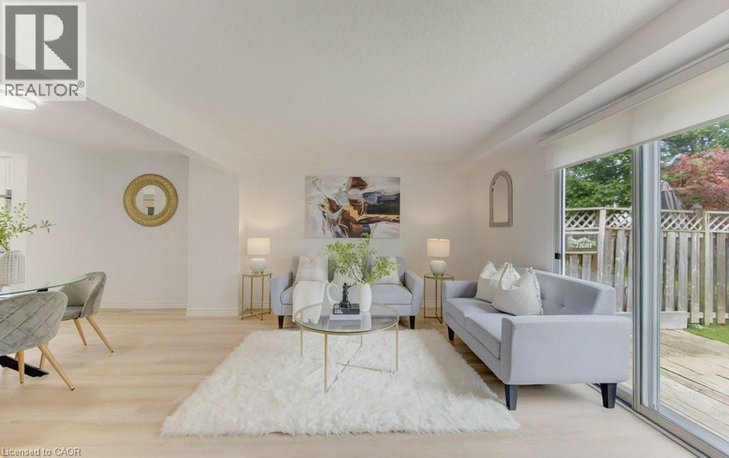 Light wood-finish flooring extends through this open living area - 603 Pinerow Crescent Unit# B, Waterloo, ON - Indoor Photo Showing Living Room