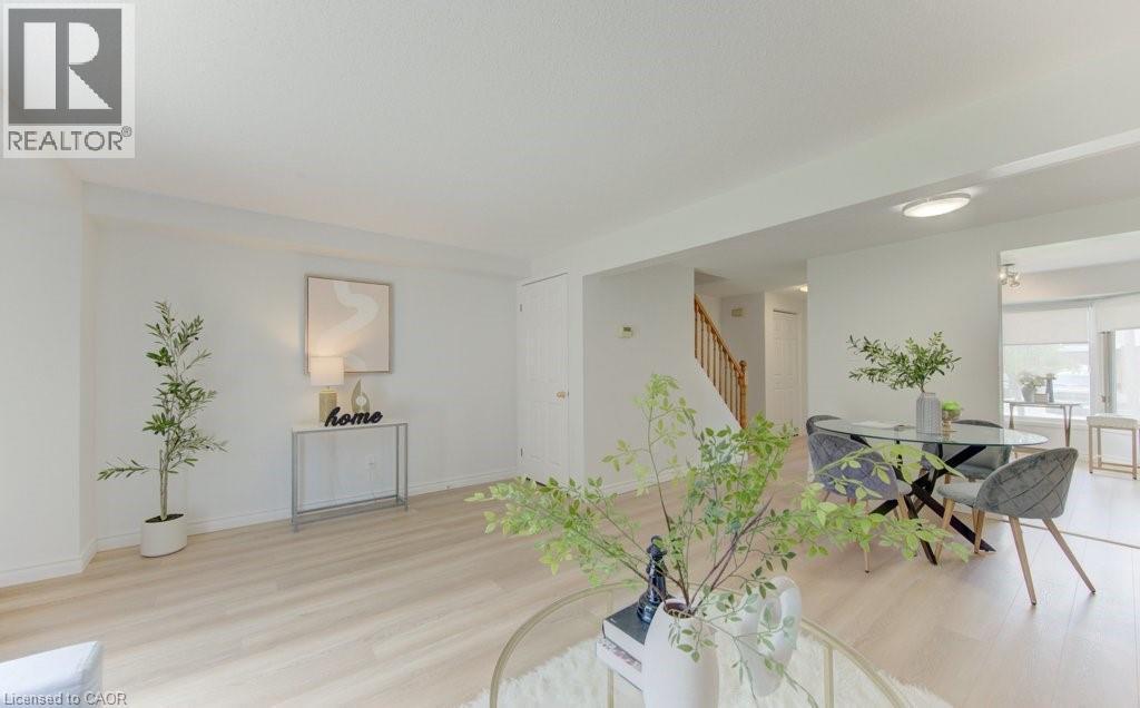 Living area with light-toned wood-finish flooring, white walls, and recessed lighting - 603 Pinerow Crescent Unit# B, Waterloo, ON - Indoor