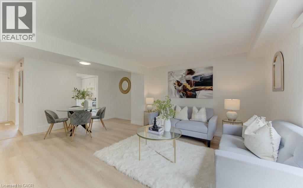 Open-concept living area featuring light wood-finish flooring, recessed lighting, and crown molding - 603 Pinerow Crescent Unit# B, Waterloo, ON - Indoor Photo Showing Living Room