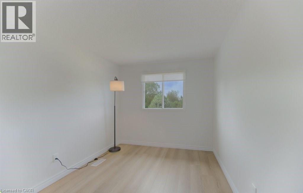 Room featuring light wood-finish flooring, white baseboards, and a single window with white trim - 603 Pinerow Crescent Unit# B, Waterloo, ON - Indoor Photo Showing Other Room
